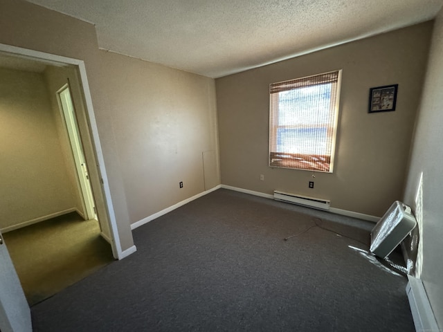 spare room with baseboards, a baseboard heating unit, dark carpet, and a textured ceiling