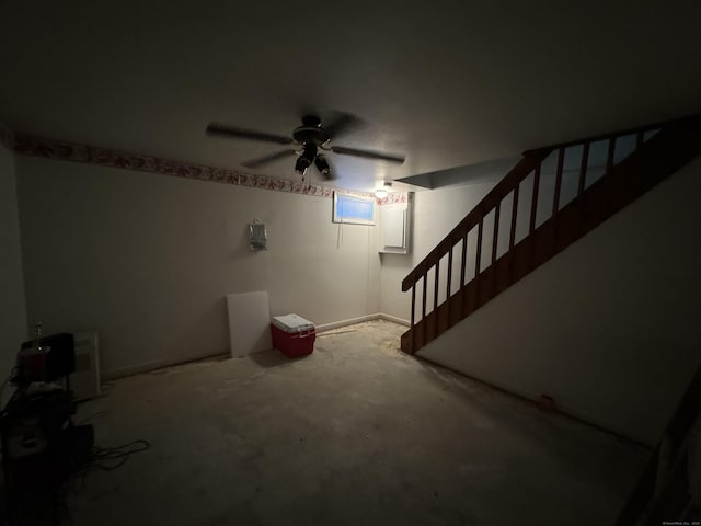 below grade area featuring a ceiling fan and stairs