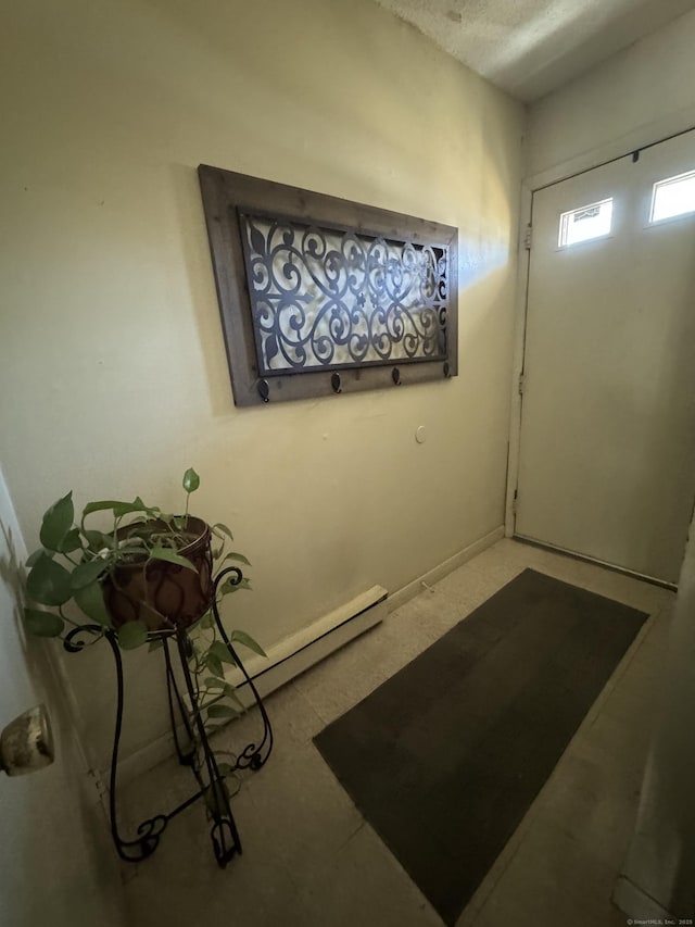 entryway featuring a baseboard heating unit