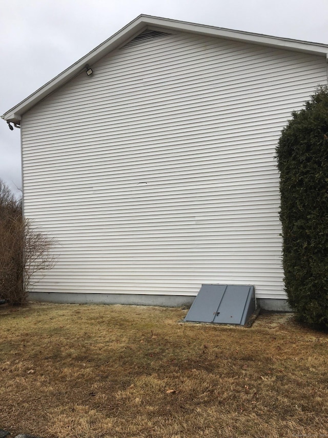 view of side of property with a yard