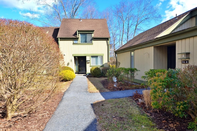 view of front of property with driveway and roof with shingles