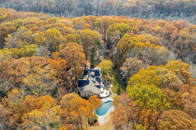 drone / aerial view with a wooded view