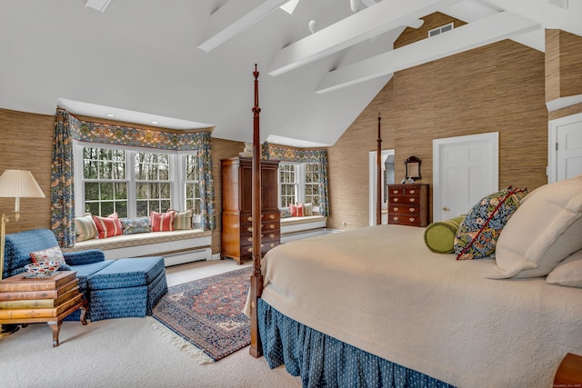 carpeted bedroom with beam ceiling and high vaulted ceiling