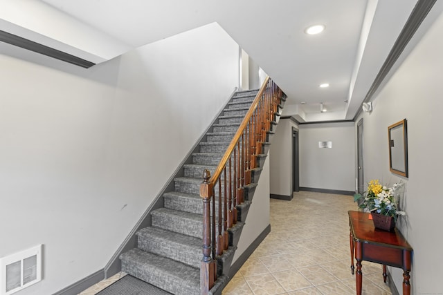 stairway with tile patterned floors, baseboards, visible vents, and recessed lighting