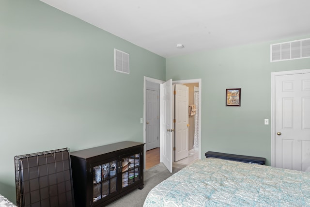 bedroom featuring carpet floors and visible vents