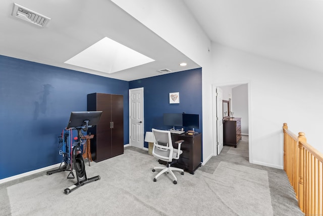 home office featuring lofted ceiling with skylight, baseboards, and visible vents