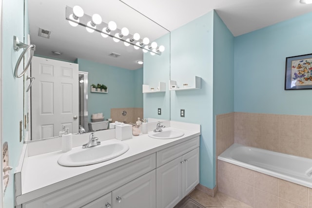 full bath with tile patterned flooring, double vanity, a sink, and a bath