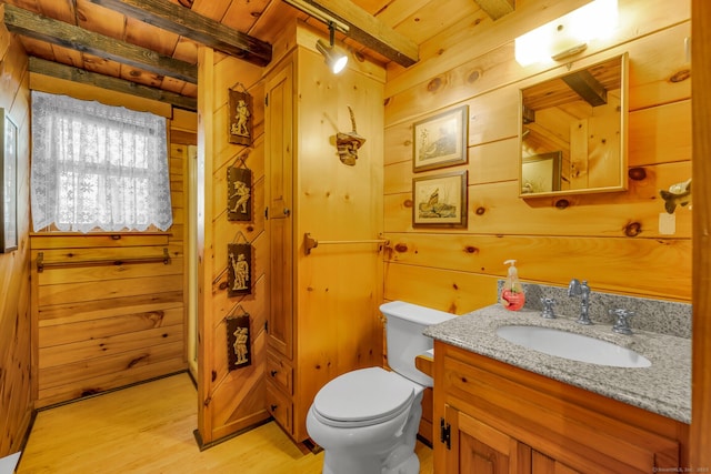 bathroom with beam ceiling, wooden walls, wood ceiling, and vanity