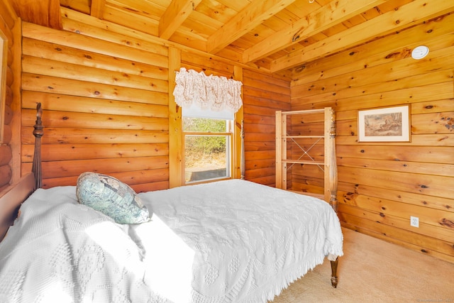 carpeted bedroom with beam ceiling and wood ceiling