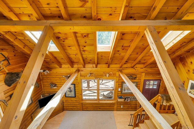 bonus room featuring wooden ceiling, a skylight, and beam ceiling