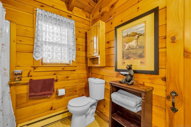 bathroom with wooden walls, toilet, and a baseboard radiator