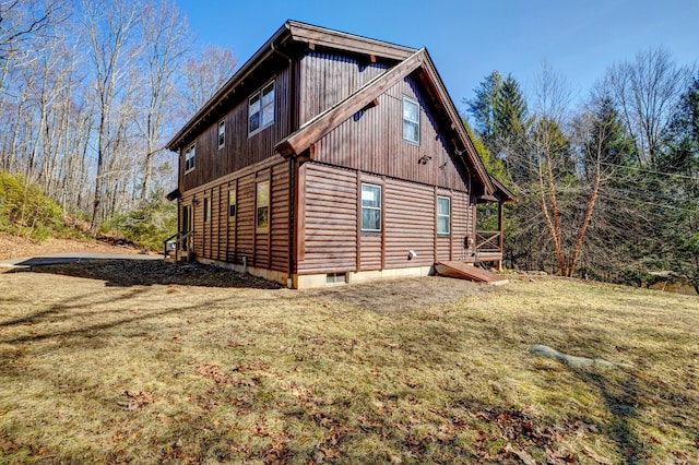 view of side of home featuring a lawn