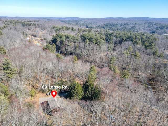 bird's eye view with a wooded view