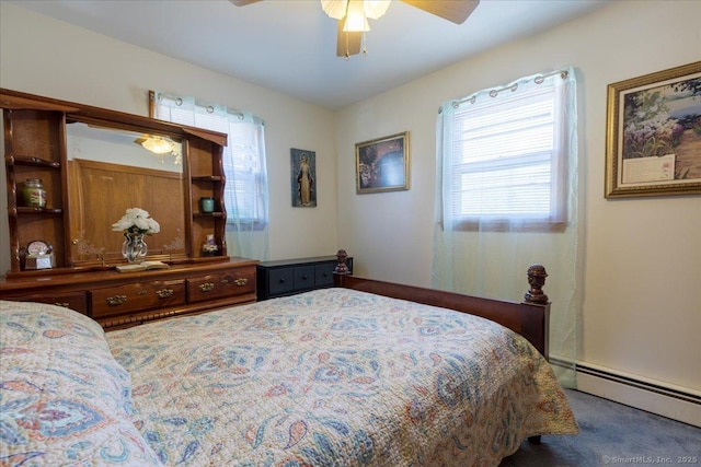 carpeted bedroom with a baseboard heating unit and a ceiling fan