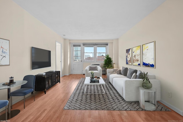 living area with baseboards and light wood-style floors