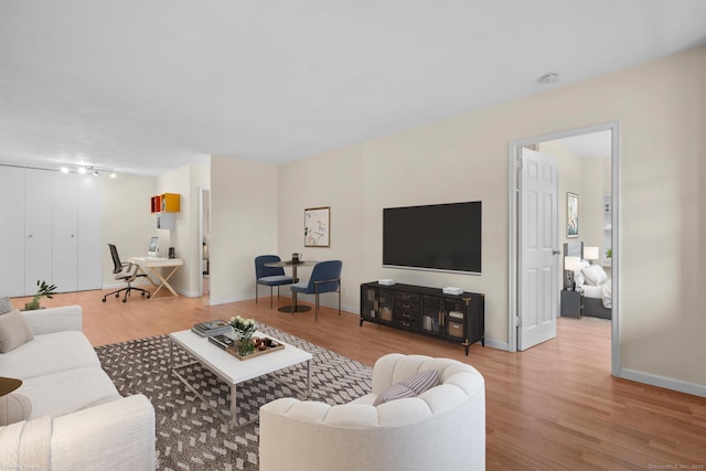 living room with baseboards and wood finished floors