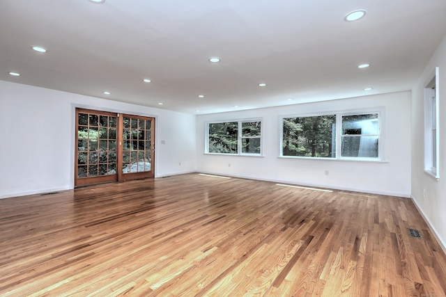 unfurnished living room featuring light wood-style floors, recessed lighting, and visible vents