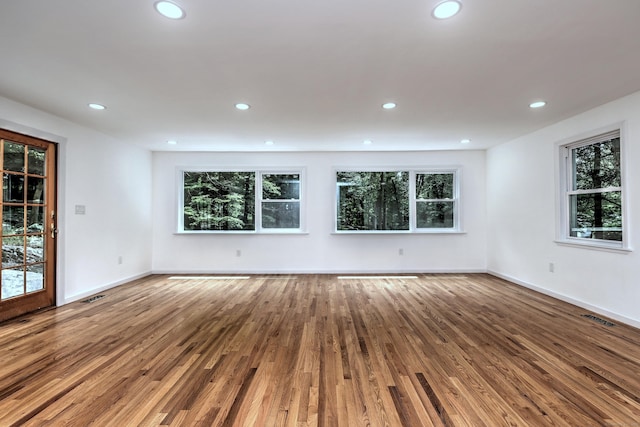 spare room featuring recessed lighting, visible vents, and wood finished floors