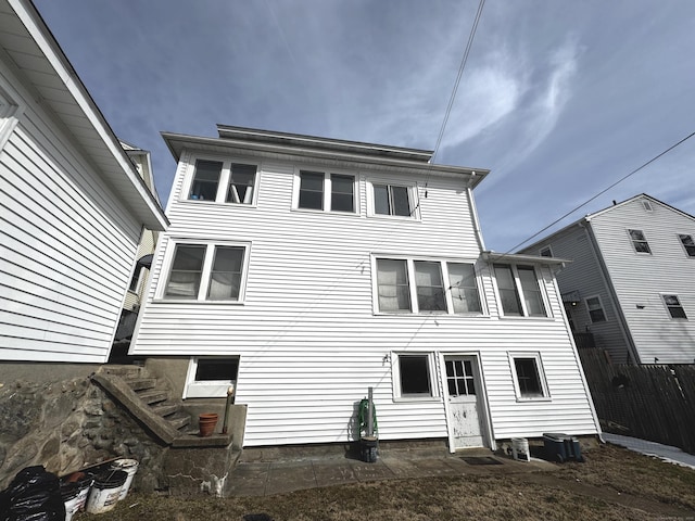 rear view of property with fence