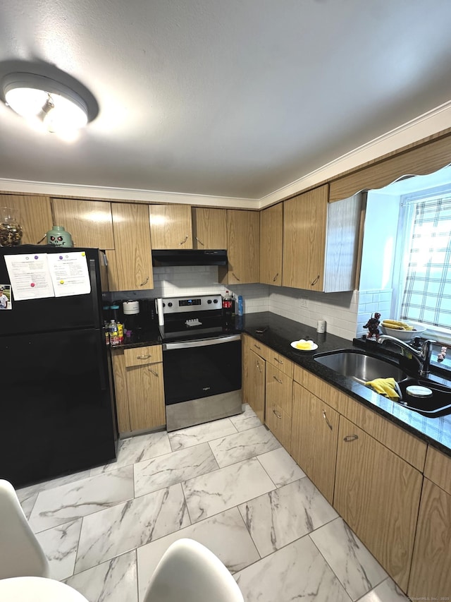 kitchen featuring a sink, stainless steel range with electric cooktop, marble finish floor, freestanding refrigerator, and dark countertops
