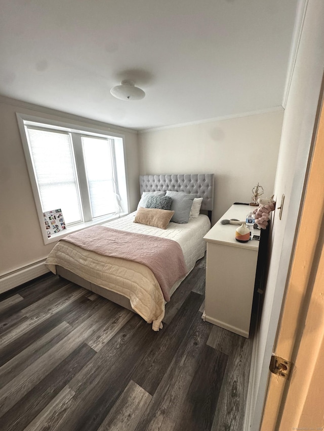 bedroom with ornamental molding, dark wood-style flooring, and baseboard heating