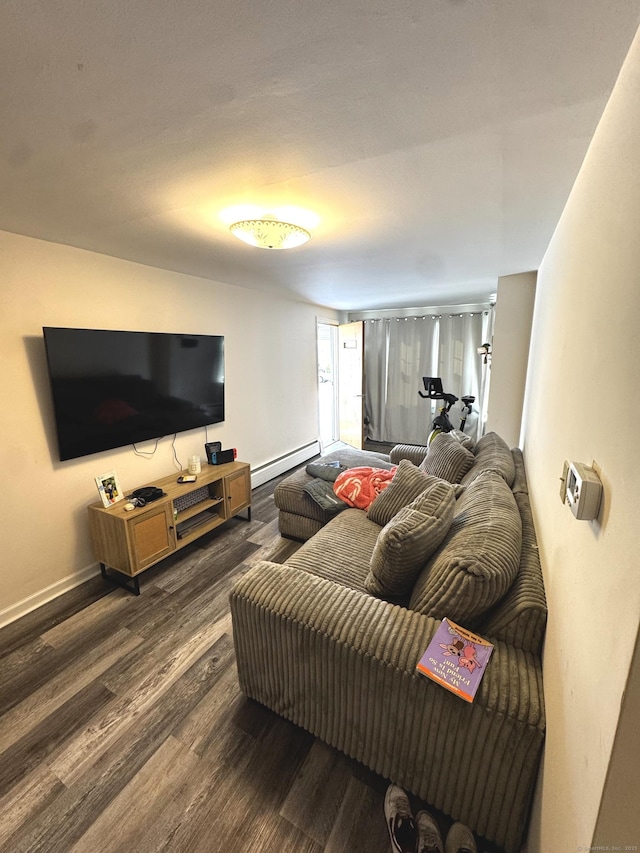 living area featuring baseboard heating, wood finished floors, and baseboards