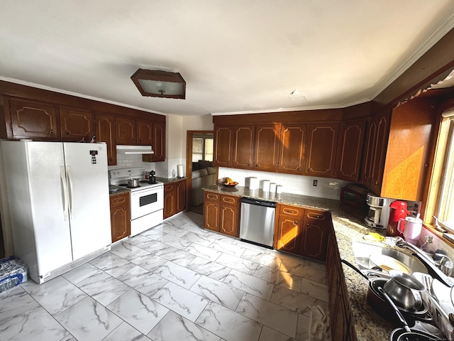 kitchen with marble finish floor, tasteful backsplash, dark stone countertops, white appliances, and under cabinet range hood