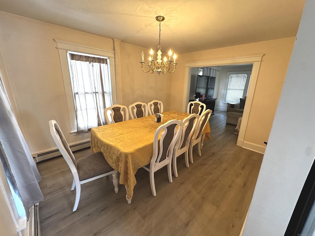 dining room featuring a notable chandelier, wood finished floors, and a healthy amount of sunlight