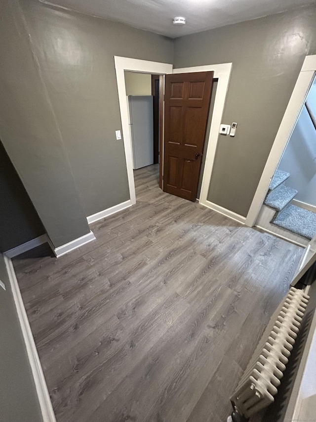 empty room featuring baseboards and wood finished floors