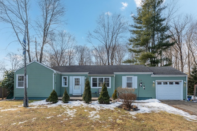 single story home featuring a garage and aphalt driveway