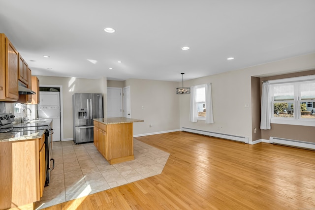 kitchen with black electric range, stainless steel refrigerator with ice dispenser, a baseboard radiator, a kitchen island, and under cabinet range hood