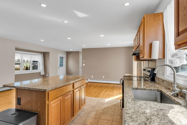 kitchen with under cabinet range hood, a baseboard heating unit, recessed lighting, a sink, and stainless steel electric stove