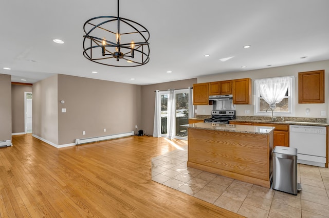 kitchen featuring a center island, stainless steel electric range oven, a baseboard heating unit, white dishwasher, and under cabinet range hood