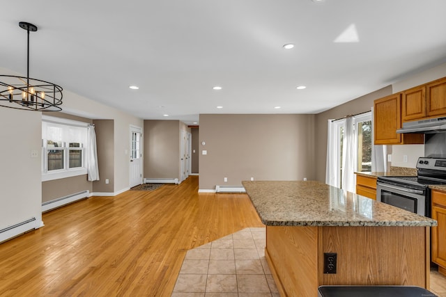 kitchen with a baseboard radiator, a center island, stainless steel electric range oven, and under cabinet range hood