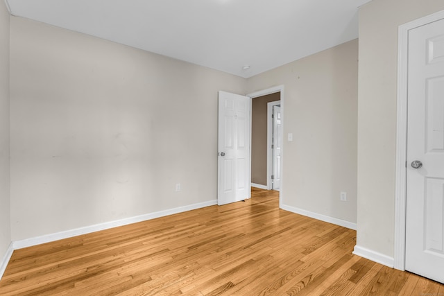 unfurnished bedroom featuring light wood-style floors and baseboards