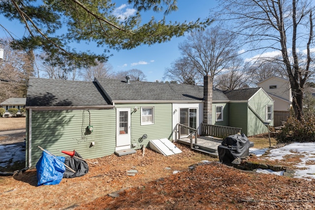 rear view of house with a shingled roof