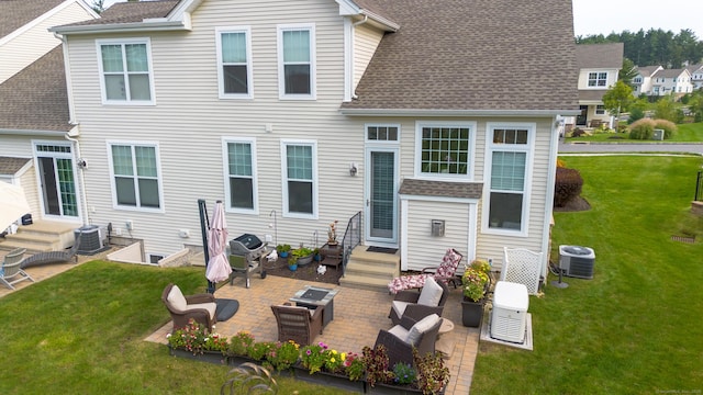 rear view of property featuring roof with shingles, a yard, a patio, outdoor lounge area, and entry steps