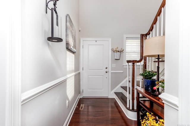 doorway to outside with stairs, baseboards, and dark wood finished floors