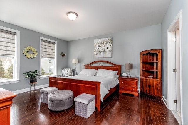 bedroom with baseboards and hardwood / wood-style flooring