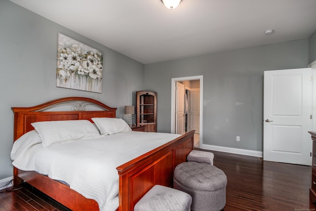 bedroom with baseboards and dark wood-type flooring