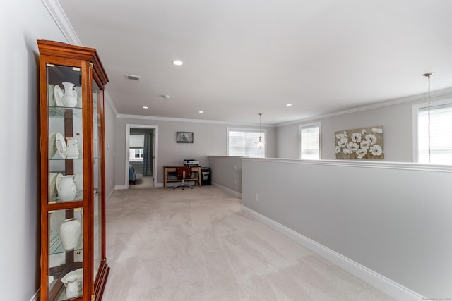 interior space with a healthy amount of sunlight, light carpet, crown molding, and baseboards