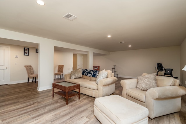 living room with baseboards, light wood-type flooring, visible vents, and recessed lighting