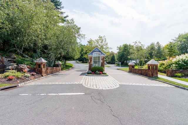 view of road featuring curbs and a gated entry