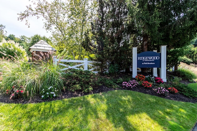 exterior space with fence and a lawn