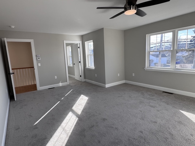 unfurnished bedroom featuring baseboards, visible vents, and carpet flooring