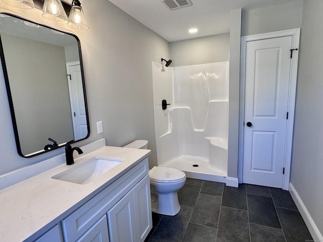 bathroom featuring toilet, visible vents, walk in shower, and vanity