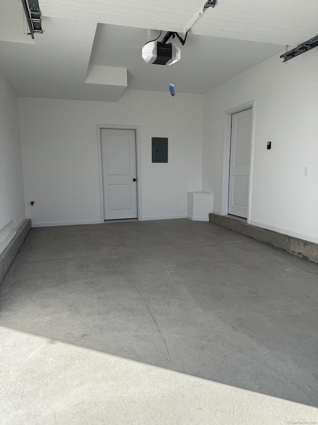 garage featuring electric panel and a garage door opener