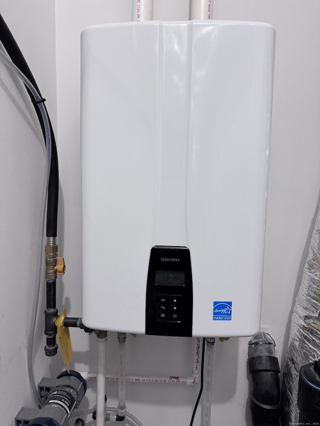 utility room featuring water heater