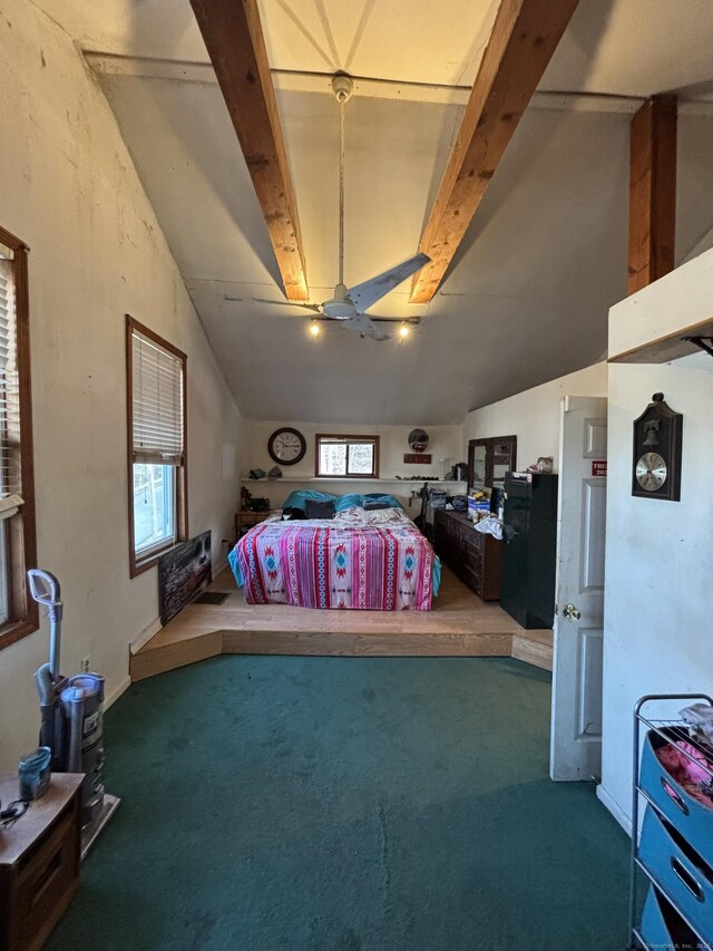 carpeted bedroom featuring lofted ceiling with skylight