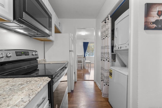 kitchen featuring white cabinets, stainless steel electric range, dark wood finished floors, and stacked washer / drying machine